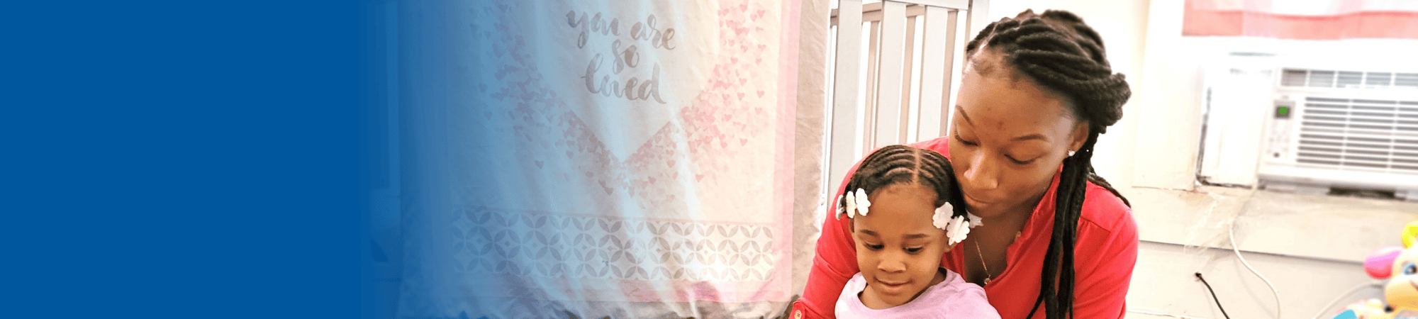 mom holding toddler daughter